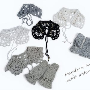 May include: A selection of crocheted collars and fingerless gloves in grey, white, and black. The accessories are displayed on a white background. The text "transform any outfit instantly" is written in cursive.