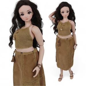 May include: A doll wearing a brown crochet halter top and a brown suede skirt with fringe details.