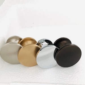 May include: Four round cabinet knobs in different finishes: brushed nickel, brass, chrome, and oil rubbed bronze.