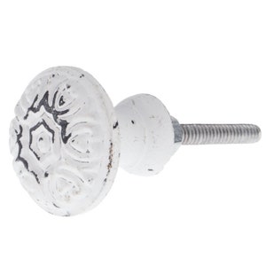 May include: White ceramic cabinet knob with a detailed floral design and a silver screw.
