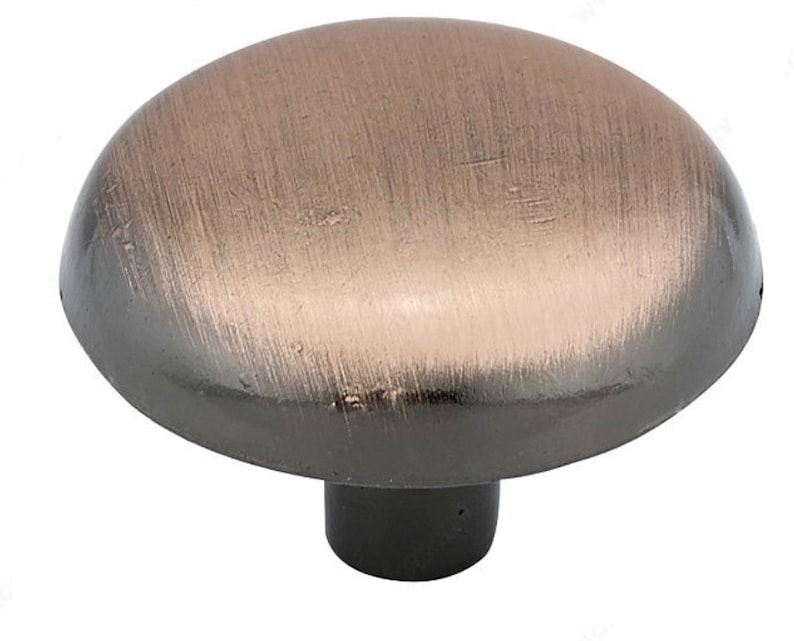 May include: A round, brushed copper cabinet knob with a black base.