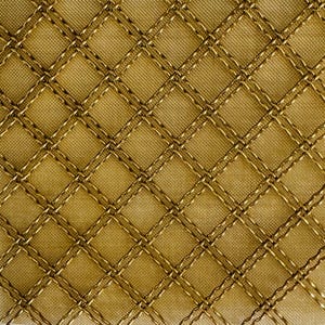 May include: A close-up of a gold fabric with a diamond pattern created by stitching. The fabric has a subtle sheen.
