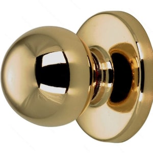 May include: A polished gold door knob with a round, spherical handle and a flat, circular base.