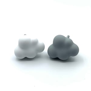 May include: Two cloud-shaped cabinet knobs, one white and one grey.