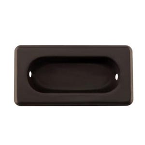 May include: A brown rectangular cabinet pull with a recessed oval handle. The pull has two small holes on either side of the handle.