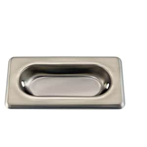 May include: A silver rectangular recessed pull handle with rounded edges and two small holes on either side of the oval opening.