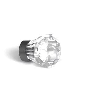May include: A clear, faceted, diamond-shaped knob with a dark grey cylindrical base. The transparent top features multiple geometric cut surfaces that reflect light, while the solid dark grey metal base provides a contrasting mounting point.