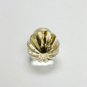 May include: A clear glass cabinet knob with a gold metal base and a fluted design.