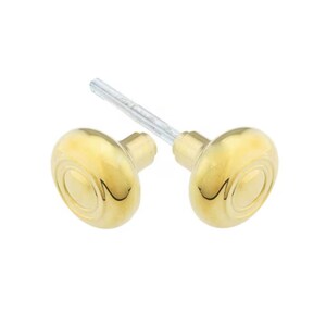 May include: Two polished brass door knobs with an oval shape and concentric circle detailing. The knobs are connected by a silver-colored spindle, designed for installation on a door. The hardware has a shiny, reflective surface.