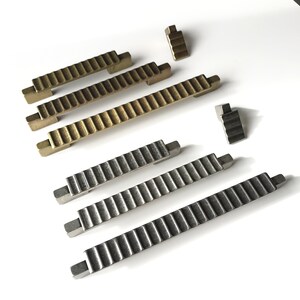 May include: A set of six metal cabinet door pulls in two finishes: gold and silver. The pulls are all in the shape of a staircase with a textured surface.