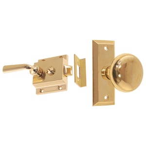 May include: A polished brass door knob set with a lever handle and a round knob. The set includes a latch, strike plate, and a separate door stop.