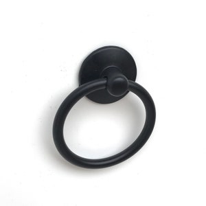 May include: Black ring pull handle with a round base. The handle is made of metal and has a smooth finish.