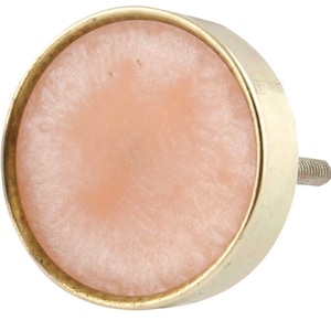 May include: A round, pink and gold cabinet knob with a textured surface.