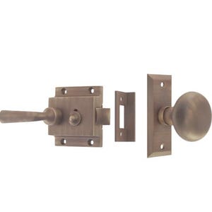 May include: A set of antique-style door hardware in a brushed brass finish. The set includes a door knob, a latch, and a strike plate.