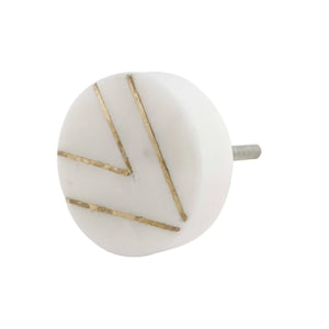 May include: White marble cabinet knob with a gold geometric design.