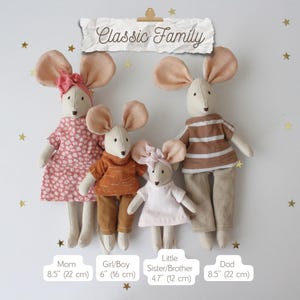 May include: A family of four mouse dolls, each with large ears and dressed in various outfits. The dolls are labeled "Mom" and "Dad" at 8.5 inches (22 cm) tall, "Girl/Boy" at 6 inches (16 cm), and "Little Sister/Brother" at 4.7 inches (12 cm). The text "Classic Family" is at the top.