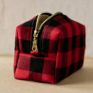 Red and black buffalo plaid pattern with antique bronze zipper track and pull.