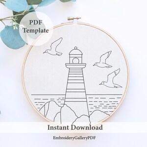 May include: A black and white line drawing of a lighthouse, seagulls, and ocean waves, framed in a wooden embroidery hoop. The words "PDF Template" and "Instant Download" are visible. The Etsy shop name "EmbroideryGalleryPDF" is also visible.