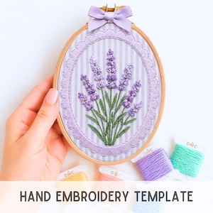 May include: Oval embroidery hoop featuring a lavender design. The lavender is embroidered in shades of purple and green, set against a striped background. The hoop is adorned with a lavender bow at the top. The text "HAND EMBROIDERY TEMPLATE" is at the bottom.
