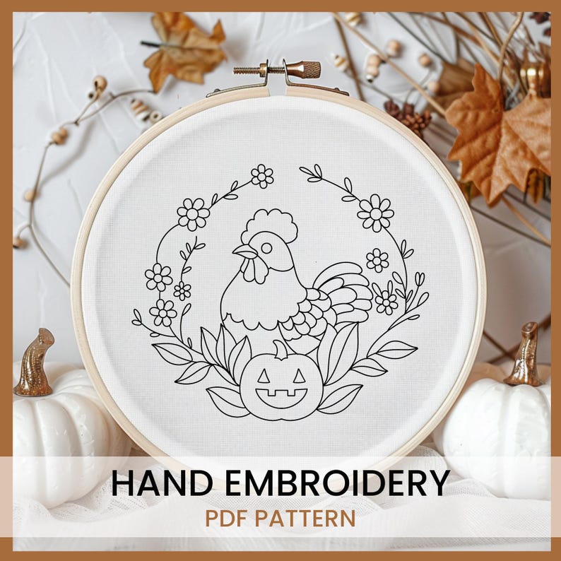 May include: Black and white line art embroidery pattern of a rooster with a pumpkin in a wreath of flowers. The pattern is in a hoop on a white background.  Hand Embroidery PDF Pattern.