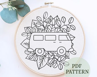 May include: Black and white line art embroidery pattern of a vintage van with floral details. The pattern is displayed on a white background in a wooden embroidery hoop. The text "PDF PATTERN" is written in green on a white circle.