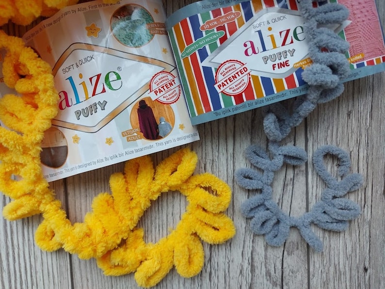 May include: Two skeins of yarn, one yellow and one gray, with the Alize brand label visible. The label says "Soft & Quick" and "Puffy" for the yellow yarn and "Soft & Quick" and "Puffy Fine" for the gray yarn.