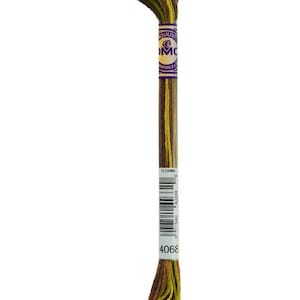 May include: A single skein of DMC embroidery floss in shades of brown, yellow, and green. The label is purple and white with the DMC logo and product information. The product code is 4068.