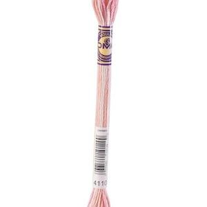 May include: A single skein of DMC embroidery floss in shades of pink and white. The label is purple and gold. The product code 4110 is visible on the label. This thread is used for embroidery and cross-stitch projects.