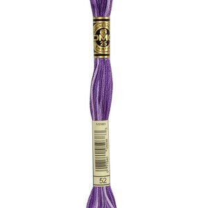 May include: A skein of DMC embroidery floss in shades of purple and white. The label reads "DMC 25" and "8 m (8.7 yds)". The color number "52" is visible. Ideal for cross-stitch, embroidery, and other needlecraft projects.