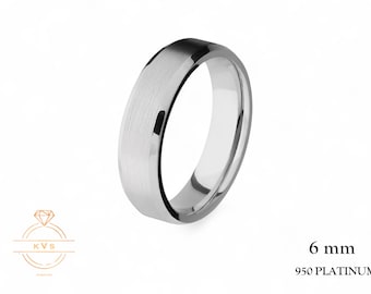 May include: A 6 mm wide platinum ring with a brushed metal finish. The ring is a bright silver colour and has a smooth, polished interior. The text "950 PLATINUM" is visible.