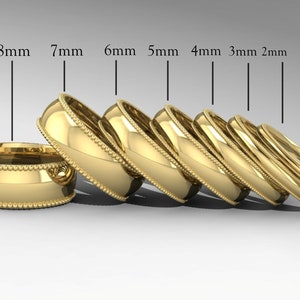May include: A set of seven gold wedding bands in different widths, ranging from 2mm to 8mm. The bands are all 10K gold and have a beaded edge.