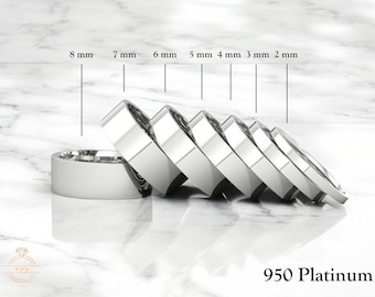 May include: A set of seven platinum wedding bands in different sizes, ranging from 2 mm to 8 mm in width. The bands are arranged in a row, with the largest band on the left and the smallest band on the right. The bands are all polished and have a smooth, shiny finish. 950 Platinum.