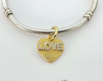Bangle Bracelet with Engraved Love Tag and 14k Gold Heart Charm Sterling Silver Bangle Bracelet with Engraved Love Tag and 14k Gold Heart Charm Sterling Silver