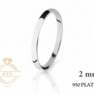 May include: A simple, 2 mm wide platinum wedding band. 950 Platinum.