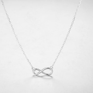 May include: A silver infinity symbol necklace with a delicate chain.