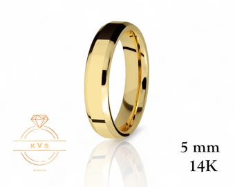 May include: A gold-colored ring with a 5 mm band. The ring has a polished finish and a faceted design on the edges. The text "14K" is visible. The ring is displayed on a white background.