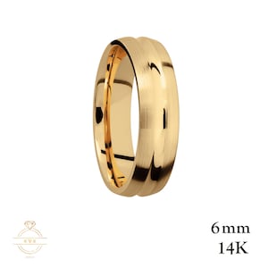 May include: A 6mm wide 14K gold wedding band with a brushed finish and a slightly rounded edge.