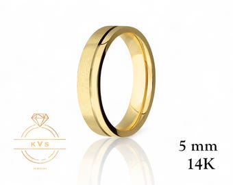 May include: A gold-colored ring with a brushed center band and polished edges. The ring is 5 mm wide and is marked as 14K gold. The ring is displayed on a white surface with its reflection visible.