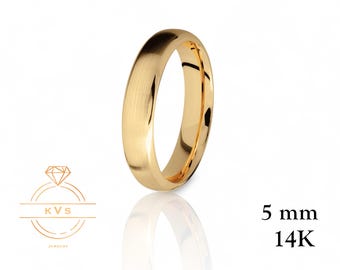 May include: A gold-colored ring with a brushed finish. The ring is 5 mm wide and made of 14K gold. The ring is displayed on a white background with a reflection. The KVS Jewelry logo is in the lower left corner.