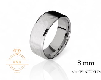 May include: A brushed platinum wedding band with a hammered finish. The band is 8 mm wide and made of 950 platinum.