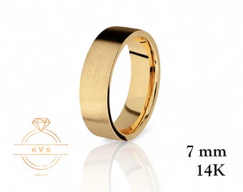 May include: A gold-colored ring with a textured surface. The ring is 7 mm wide and is marked as 14K gold. The ring is displayed on a white background with a reflection.