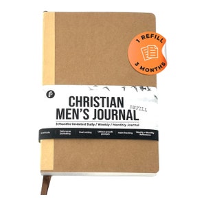 May include: A brown journal with the text "Christian Men's Journal" and "3 Months Undated Daily/Weekly/Monthly Journal". The journal has a sticker that says "1 Refill 3 Months".