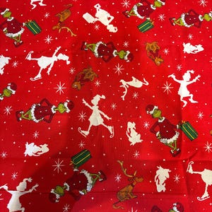 May include: Red fabric with a repeating pattern of the Grinch, reindeer, ice skaters, and snowflakes. The Grinch is wearing a Santa suit and holding a gift. The reindeer is brown. The ice skaters are white.