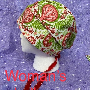May include: A white skull cap with a red, green, and pink paisley pattern. The cap has a red ribbon tie.