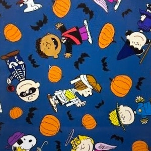 May include: A blue Halloween-themed fabric featuring cartoon characters in costumes, orange pumpkins, and black bats. The characters are dressed as a witch, skeleton, vampire, and other Halloween figures. The fabric is suitable for various craft projects.