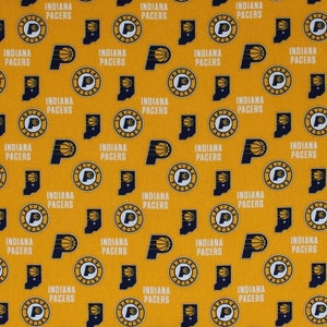 May include: A yellow fabric with a repeating pattern of the Indiana Pacers logo. The logo features a basketball and the words "Indiana Pacers".