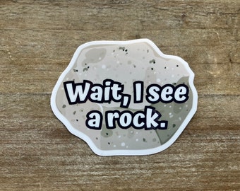 May include: A white sticker with a cartoon rock and the text "Wait, I see a rock."