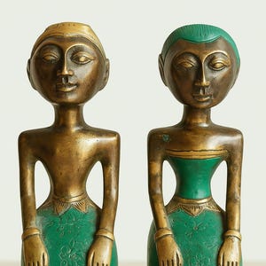 Peut inclure: Deux statues de figures en bronze avec des robes et des coiffes vertes. Les figures ont des traits stylisés, notamment des mains détaillées et une expression sereine. Les robes sont ornées de motifs floraux.