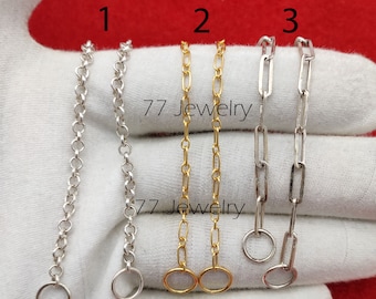May include: Three silver chains with jump rings. The chains are labelled 1, 2, and 3. Chain 1 is a fine, round chain. Chain 2 is a thicker, flat chain. Chain 3 is a thicker, flat chain with a slightly wider link.