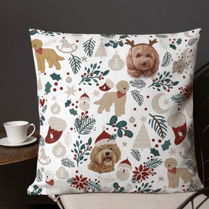 May include: A white throw pillow with a festive Christmas pattern featuring doodle dogs wearing Santa hats and reindeer antlers. The pattern also includes Christmas trees, holly, stars, and ornaments.